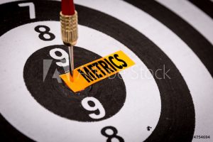 dart in bullseye of dartboard, with word "metrics"