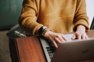 A woman types a press release for distribution