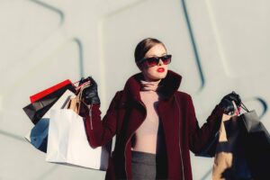 A woman carries many shopping bags in her hands