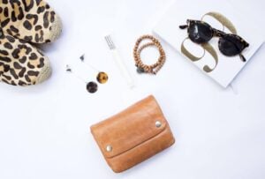 Shoes, bags, and accessories are laid out on a table.